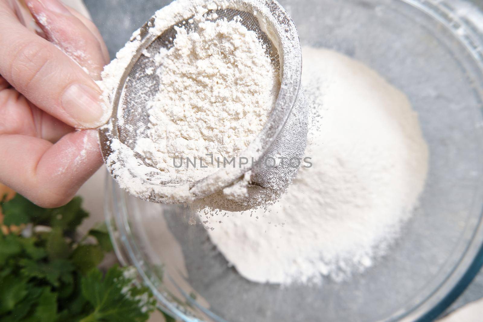 Flour is sieved with a metal sieve