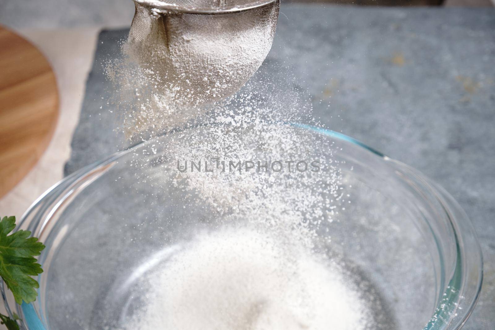 Flour is sieved with a metal sieve