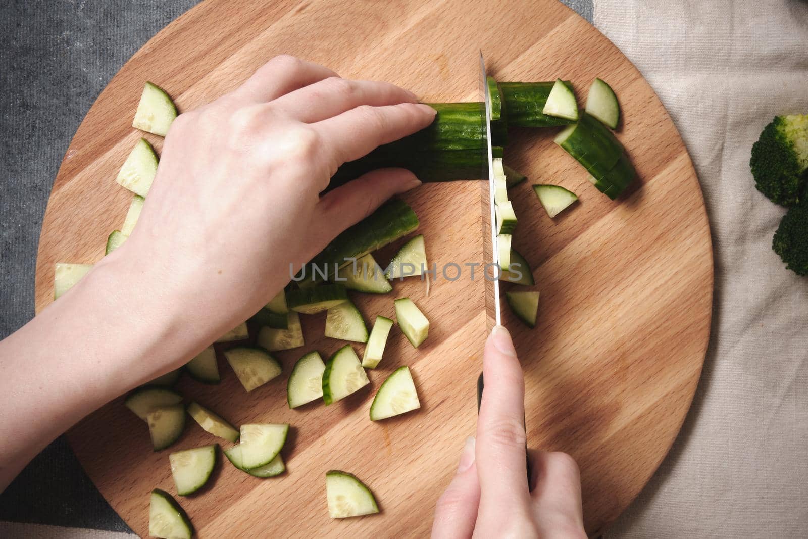 Chopping a cucumber on a cutting board