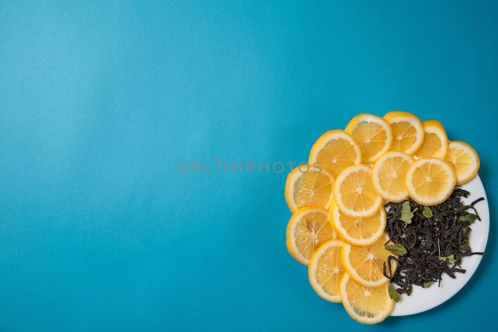 Fresh lemon lies on a blue textured background