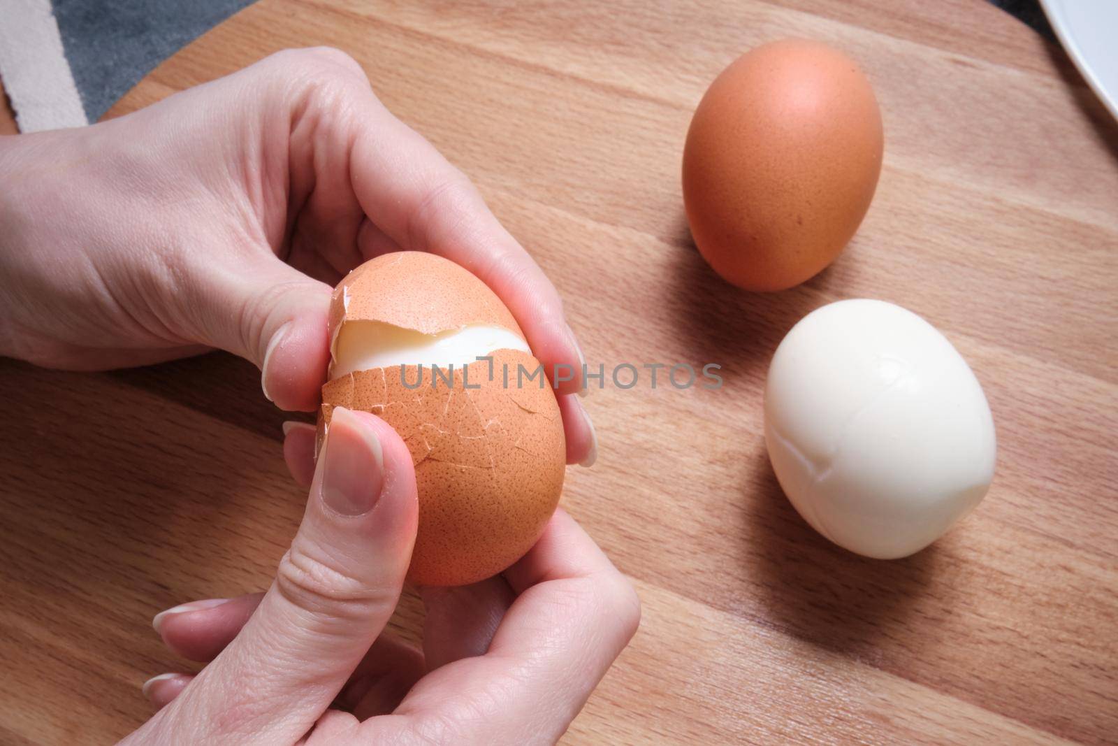 Cleaning a boiled egg with your hands