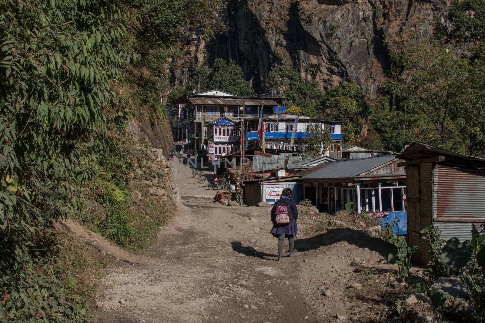 Young girl walking into a small mountain village by arvidnorberg