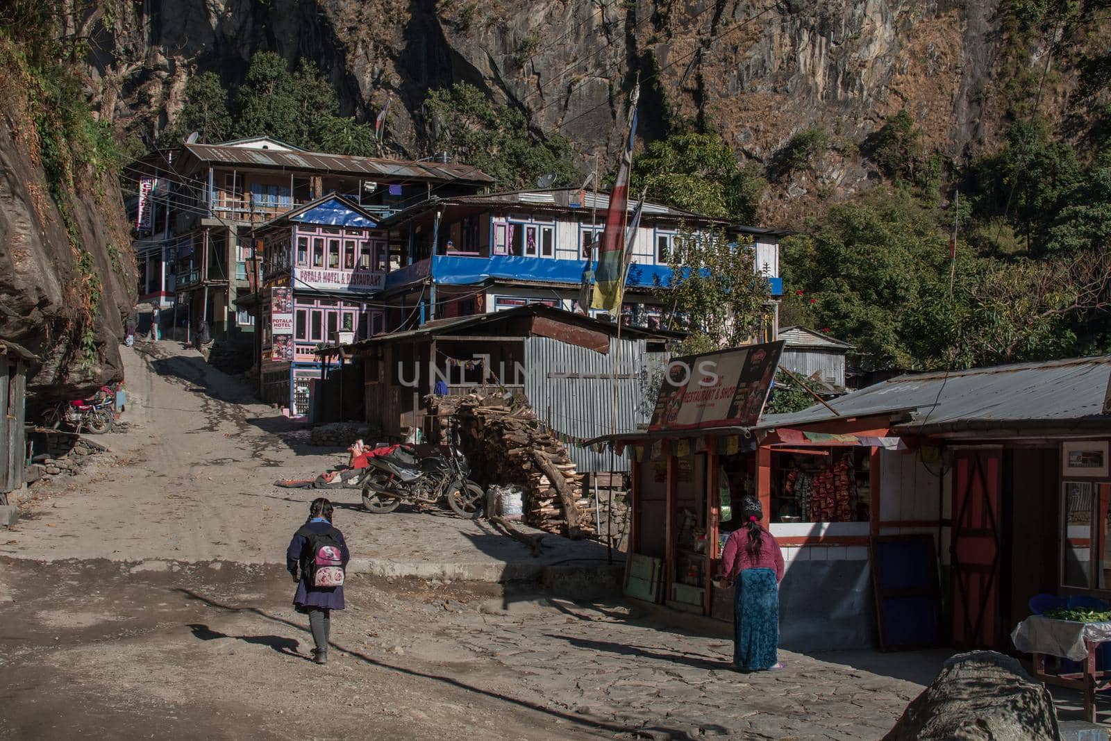 Young girl walking into a small mountain village, Annapurna circuit, Nepal