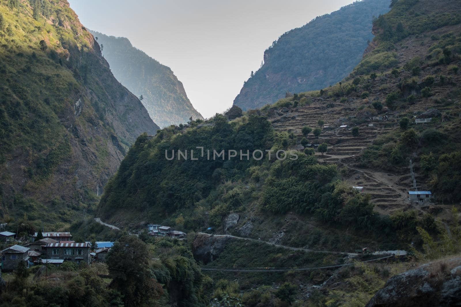 Nepalese mountain village with rice plantation terraces over the Marshyangdi river, Annapurna circuit, Himalaya, Nepal, Asia