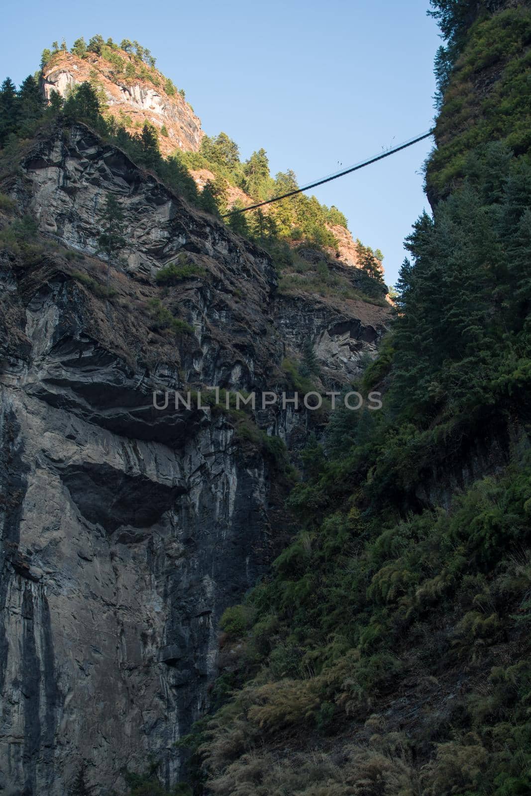 Suspension bridge high up above the Marshyangdi river gorge valley close to Dharapani, Annapurna circuit, Himalaya, Nepal, Asia