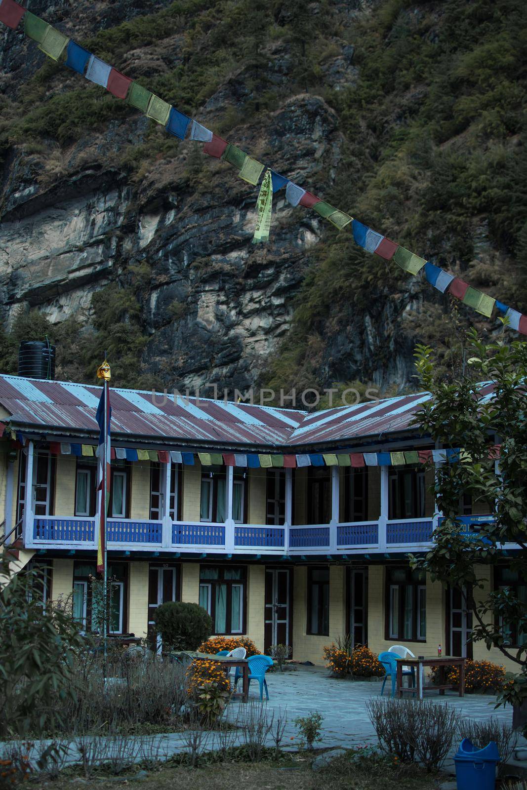 Colorful tea house lodge with prayer flags in Dharapani by arvidnorberg