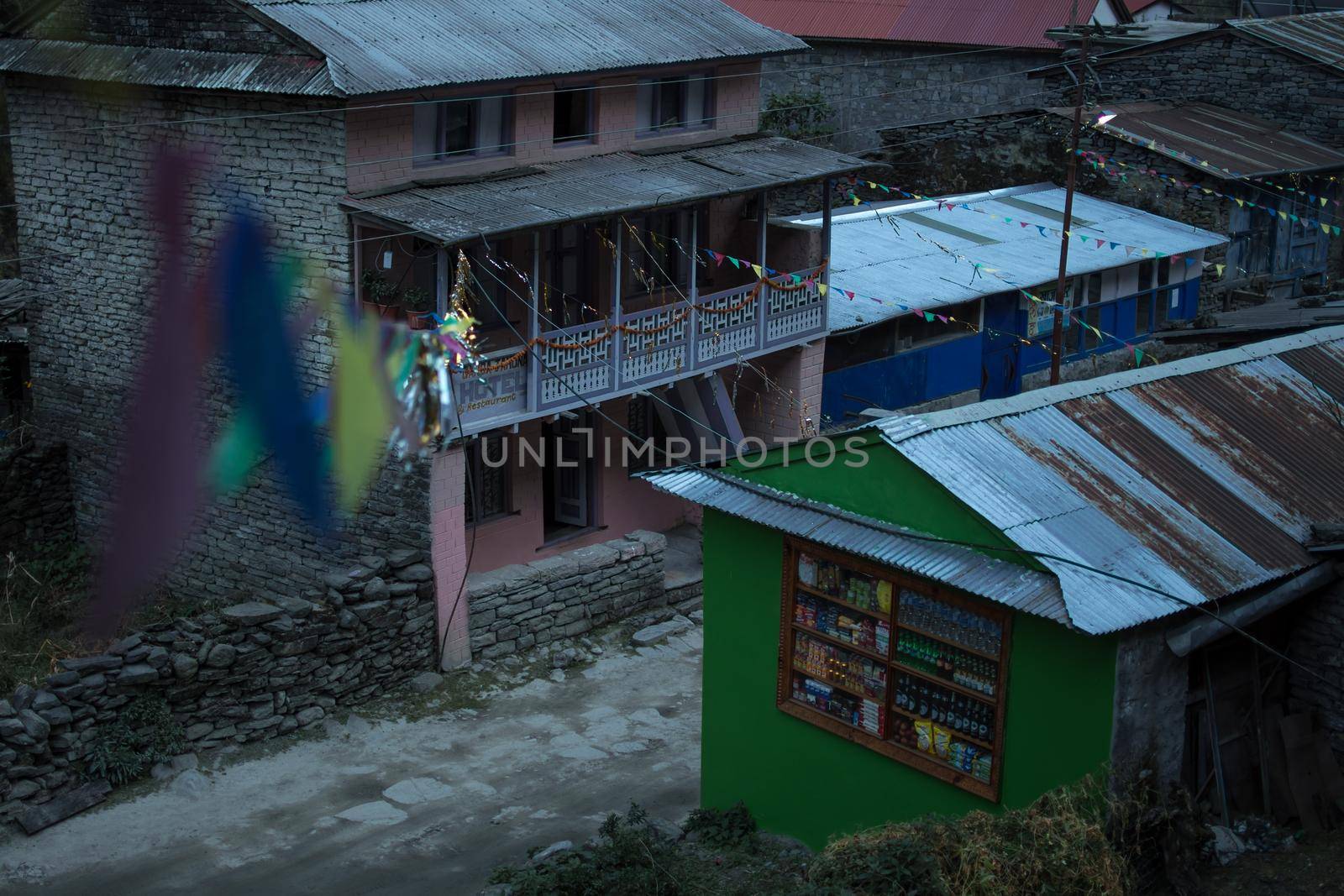 View over the mounatin village Dharapani with prayer flags by arvidnorberg