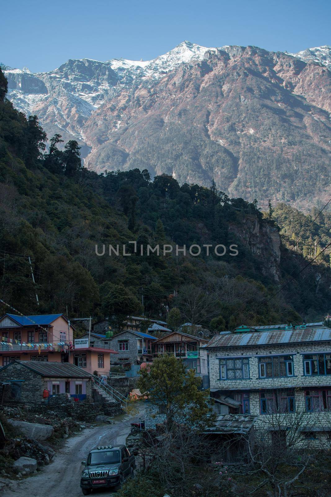 Nepalese mountain village with buddhist prayer flags along Annapurna circuit, Himalaya, Nepal, Asia