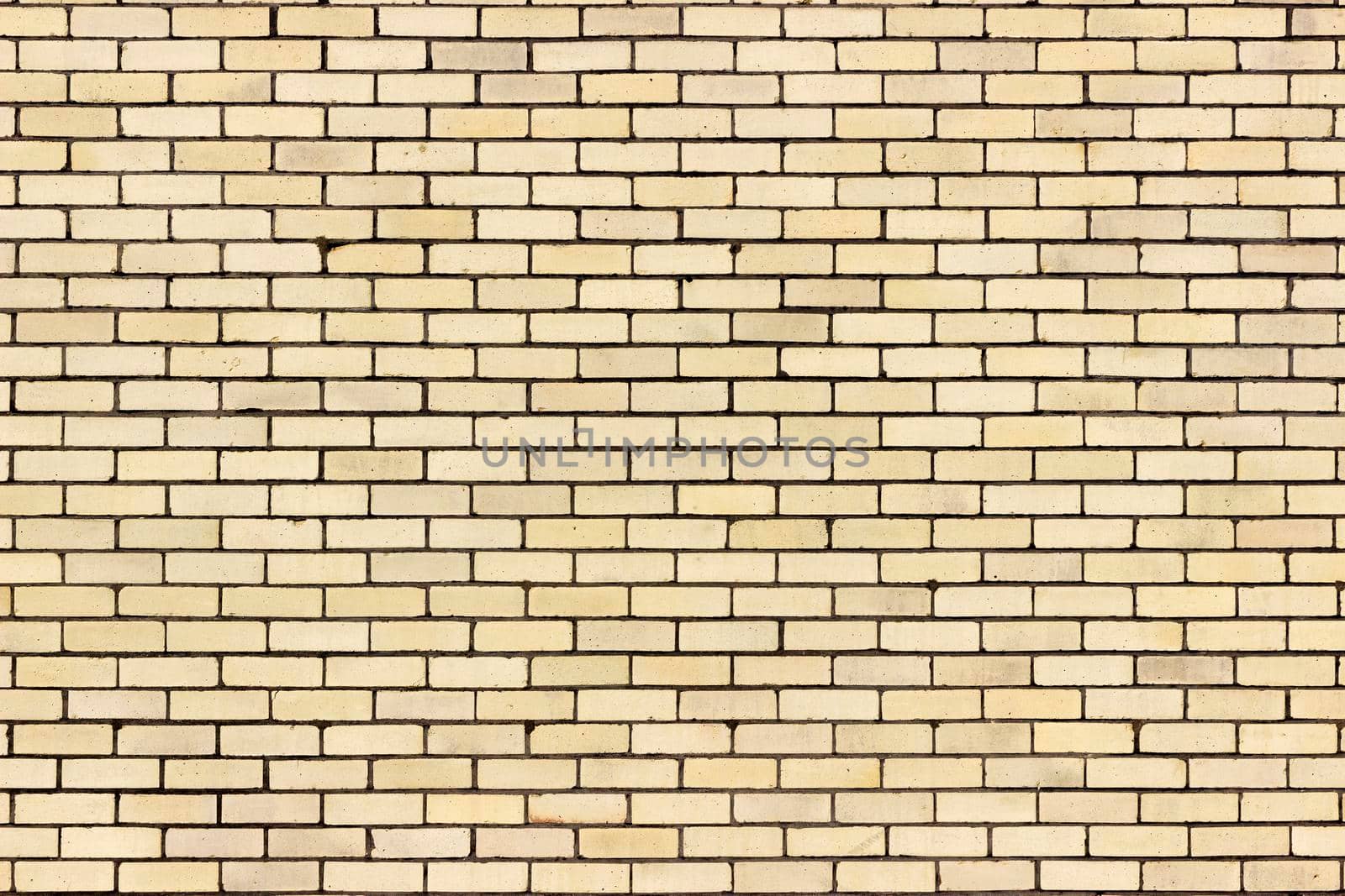 A light yellow sand colour brick wall from a distance.