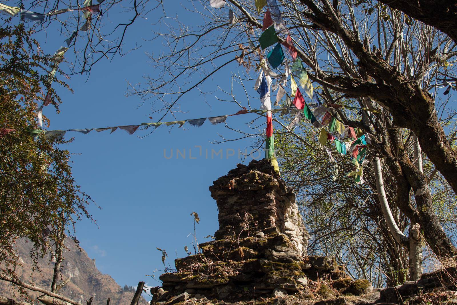 Colorful buddhist prayer flags hanging, blowing in the wind by the mountains