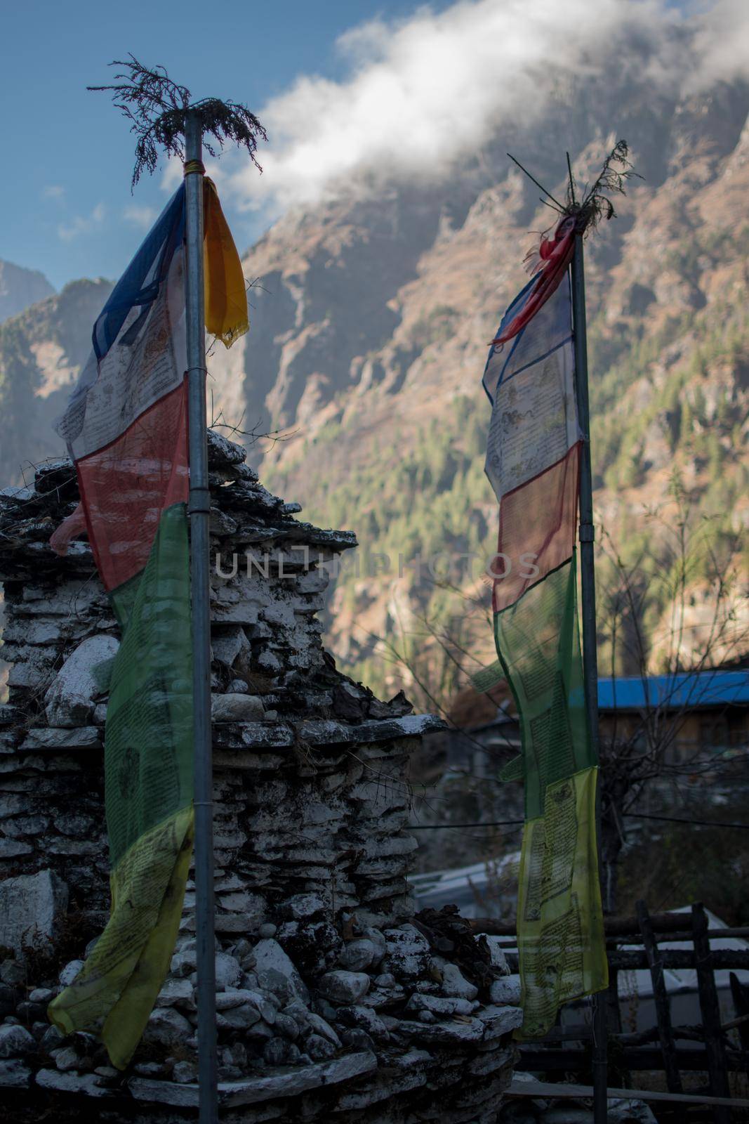 Colorful buddhist prayer flags hanging, blowing in the wind by the mountains