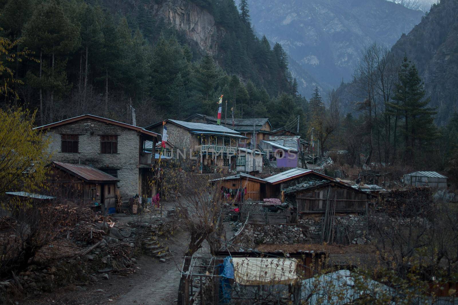 Nepalese mountain village with buddhist prayer flags along Annapurna circuit, Himalaya, Nepal, Asia