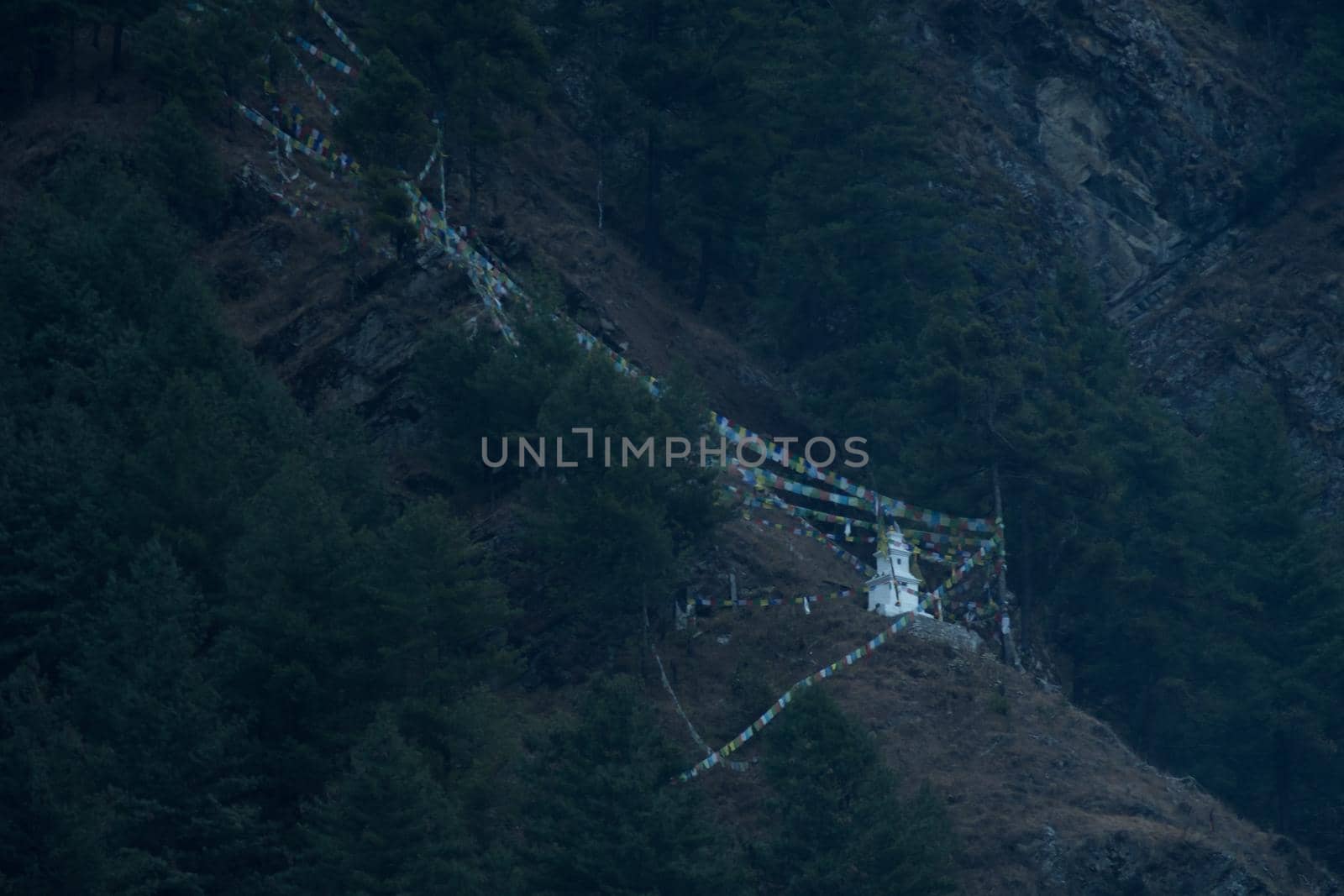 Buddhist stupa and prayer flags on the mountain side in Chame, Annapurna circuit, Himalaya, Nepal, Asia