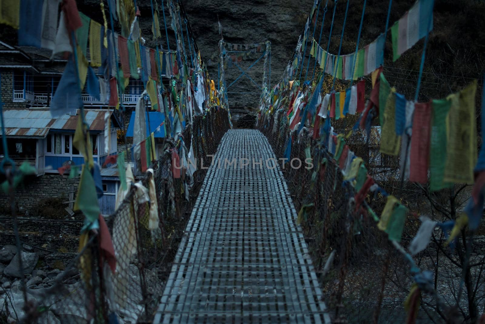 Chame suspension bridge colorful buddhist prayer flags over Marshyangdi river, Annapurna circuit, Nepal