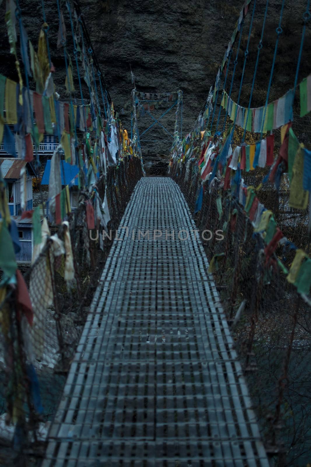 Chame suspension bridge colorful buddhist prayer flags over Marshyangdi river, Annapurna circuit, Nepal