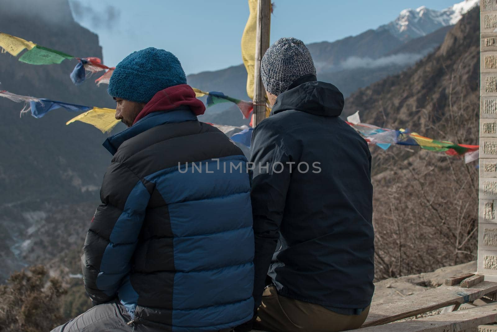 Two young hiker friends looking at the mountains over Lower Pisang, Annapurna circuit