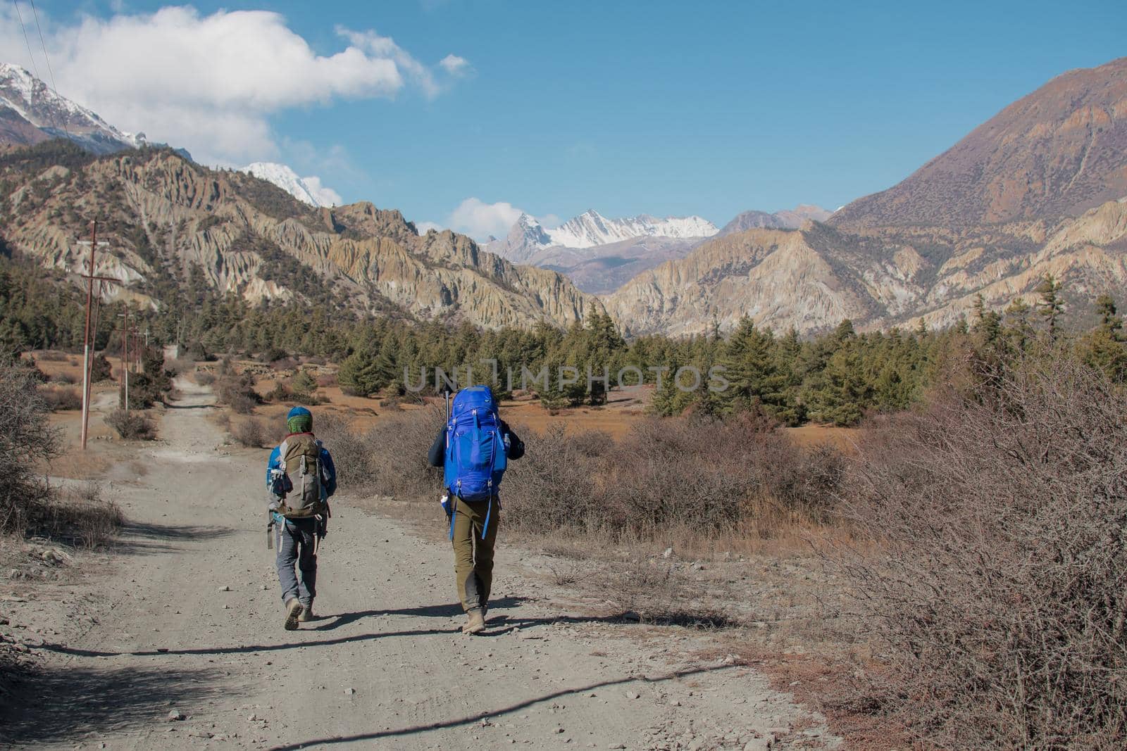 Backpacker friends surounded by mountains, trekking Annapurna circuit, Nepal, Asia