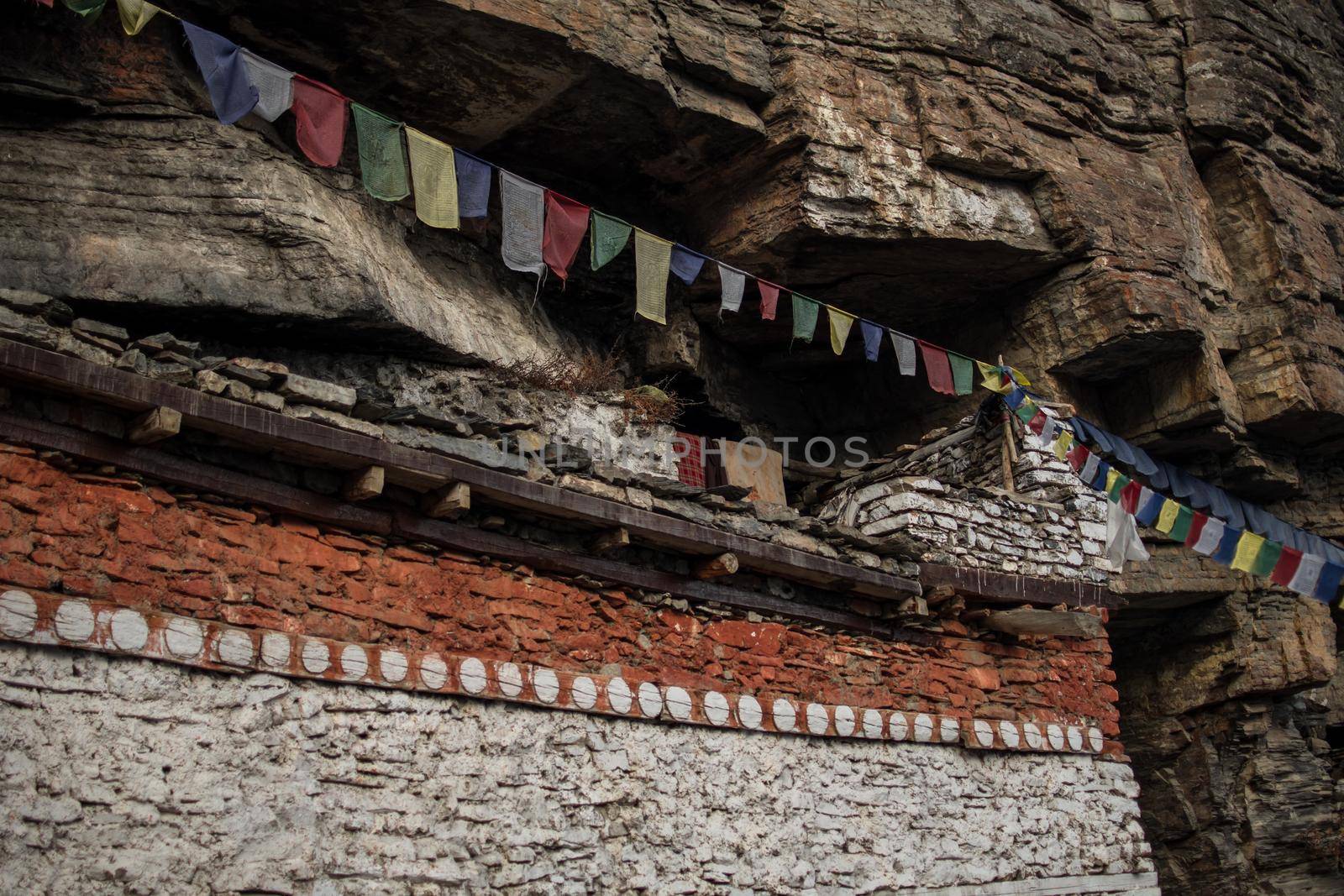 Buddhist prayer flags at Praken Gompa over Manang village, trekking Annapurna circuit