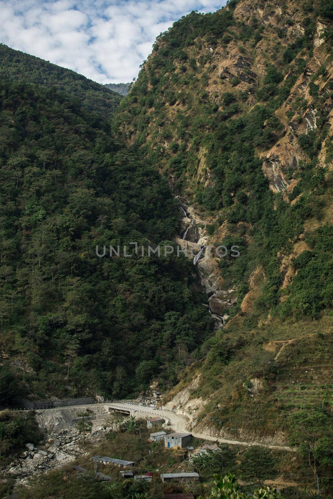 High waterfall flowinng in the nepalese mountains by arvidnorberg