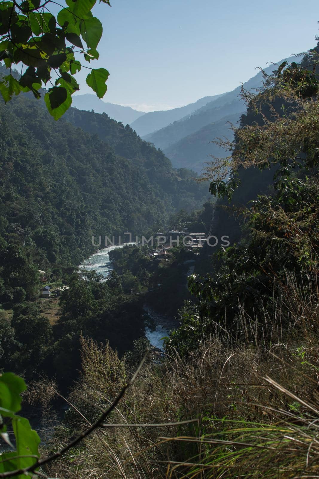 Marshyangdi river flowing through a valley close to a mounatin village by arvidnorberg