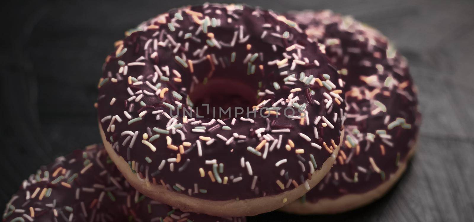 Bakery, branding and cafe concept - Frosted sprinkled donuts, sweet pastry dessert on rustic wooden background, doughnuts as tasty snack, top view food brand flat lay for blog, menu or cookbook design