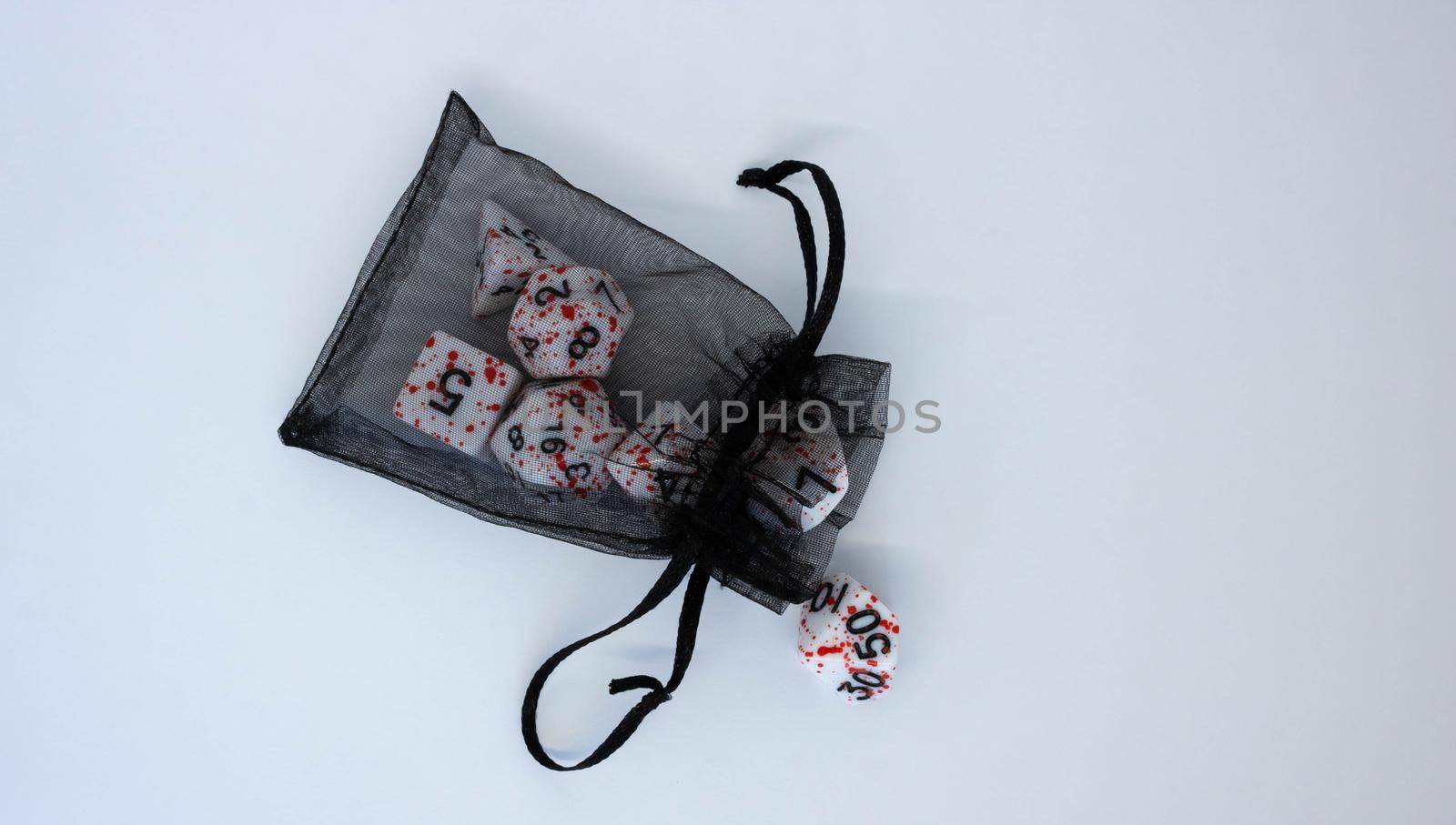 Black transparent pouch and dice isolated on white background.Flying dice.