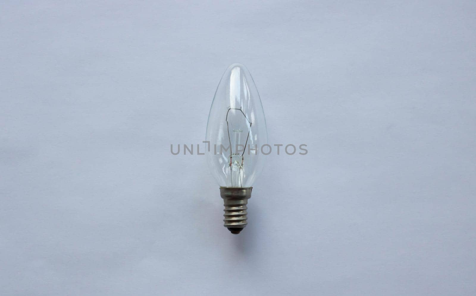 Small tungsten light bulb isolated on white background.