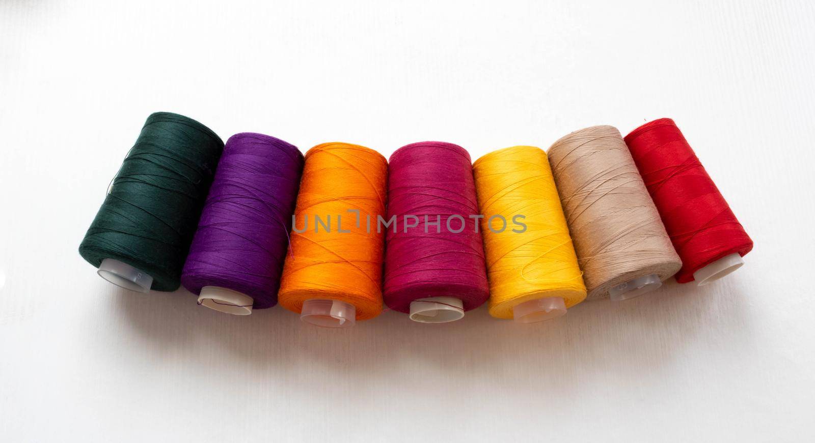 Panorama of colorful bobbins isolated on a white background.