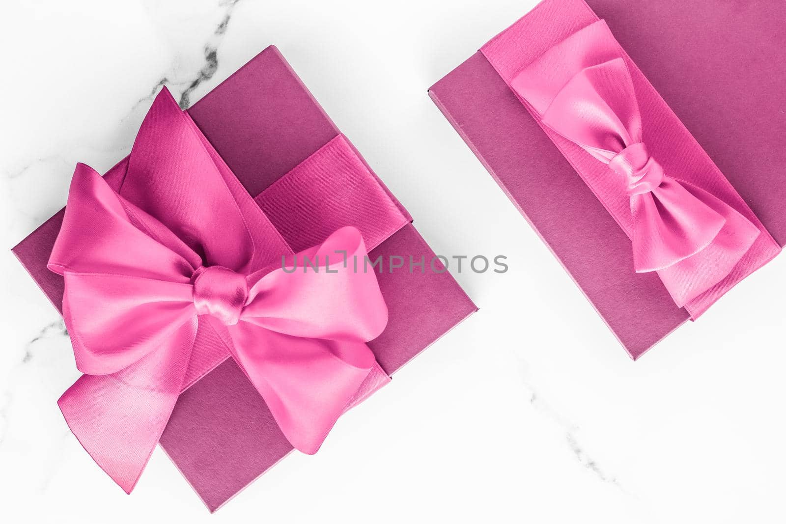 Birthday, wedding and girly branding concept - Pink gift box with silk bow on marble background, girl baby shower present and glamour fashion gift for luxury beauty brand, holiday flatlay art design