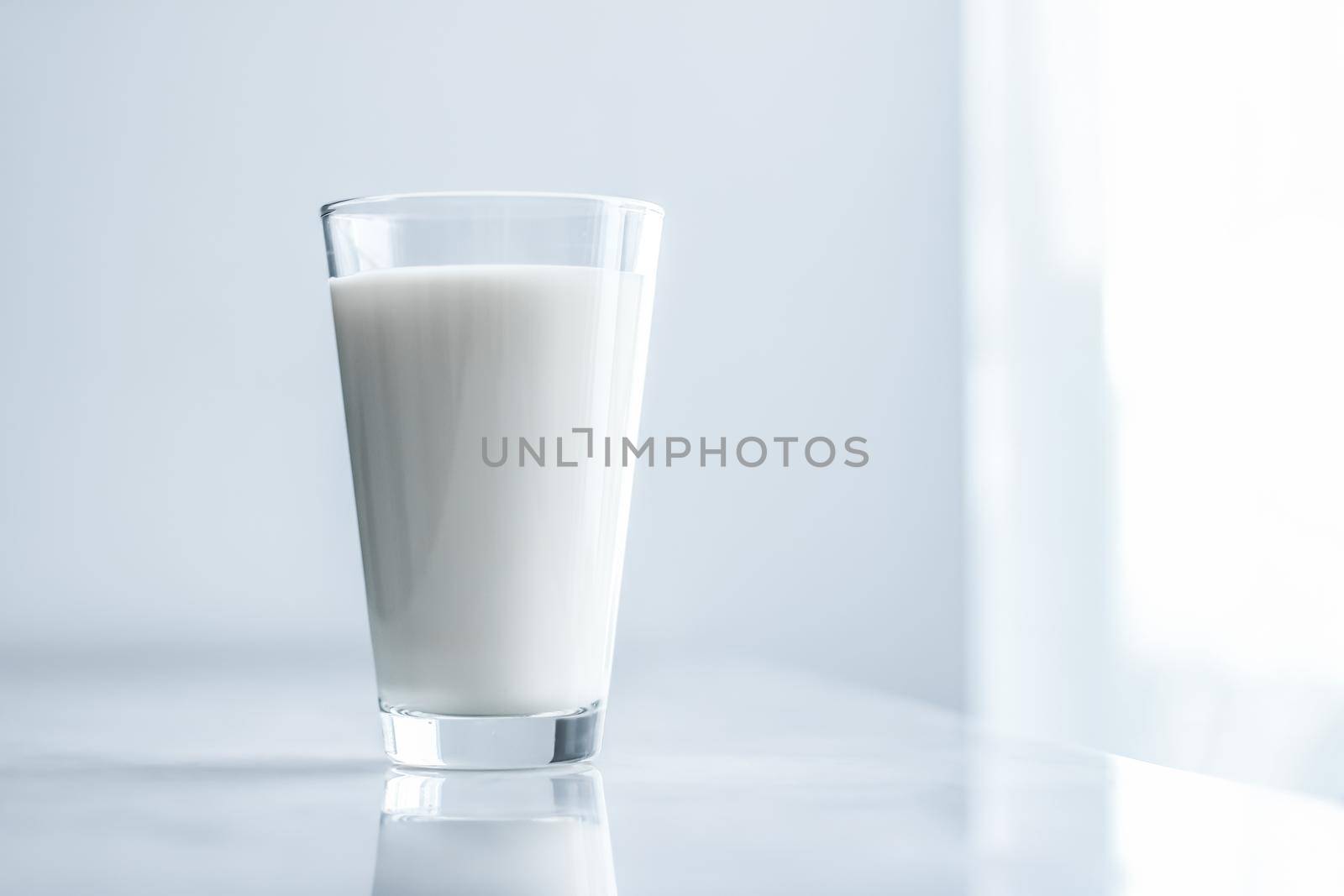 Dairy, healthy nutrition and breakfast concept - World Milk Day, full glass on marble table