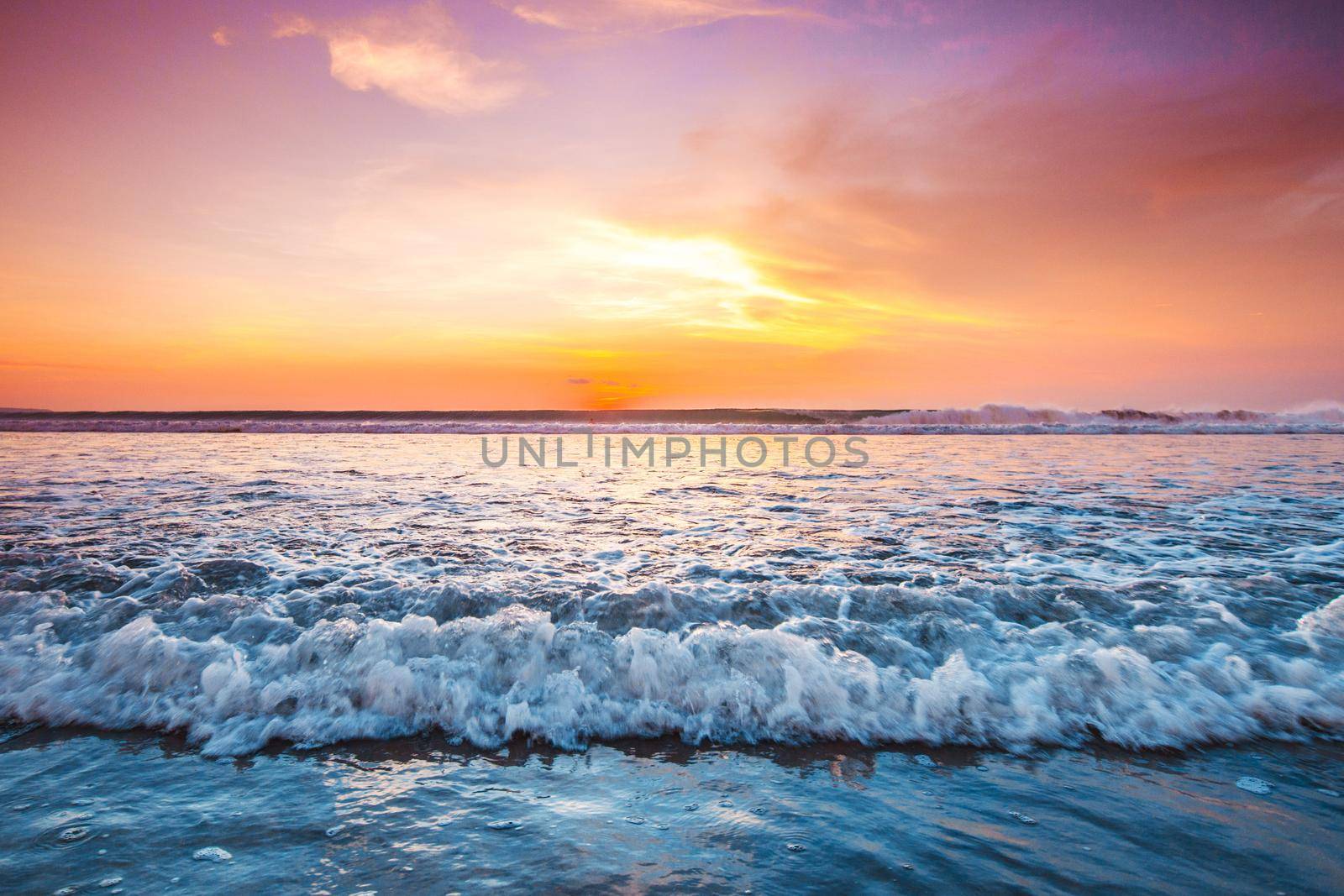 Radiant sunset from Bali Double Six beach surf waves and colorful clouds