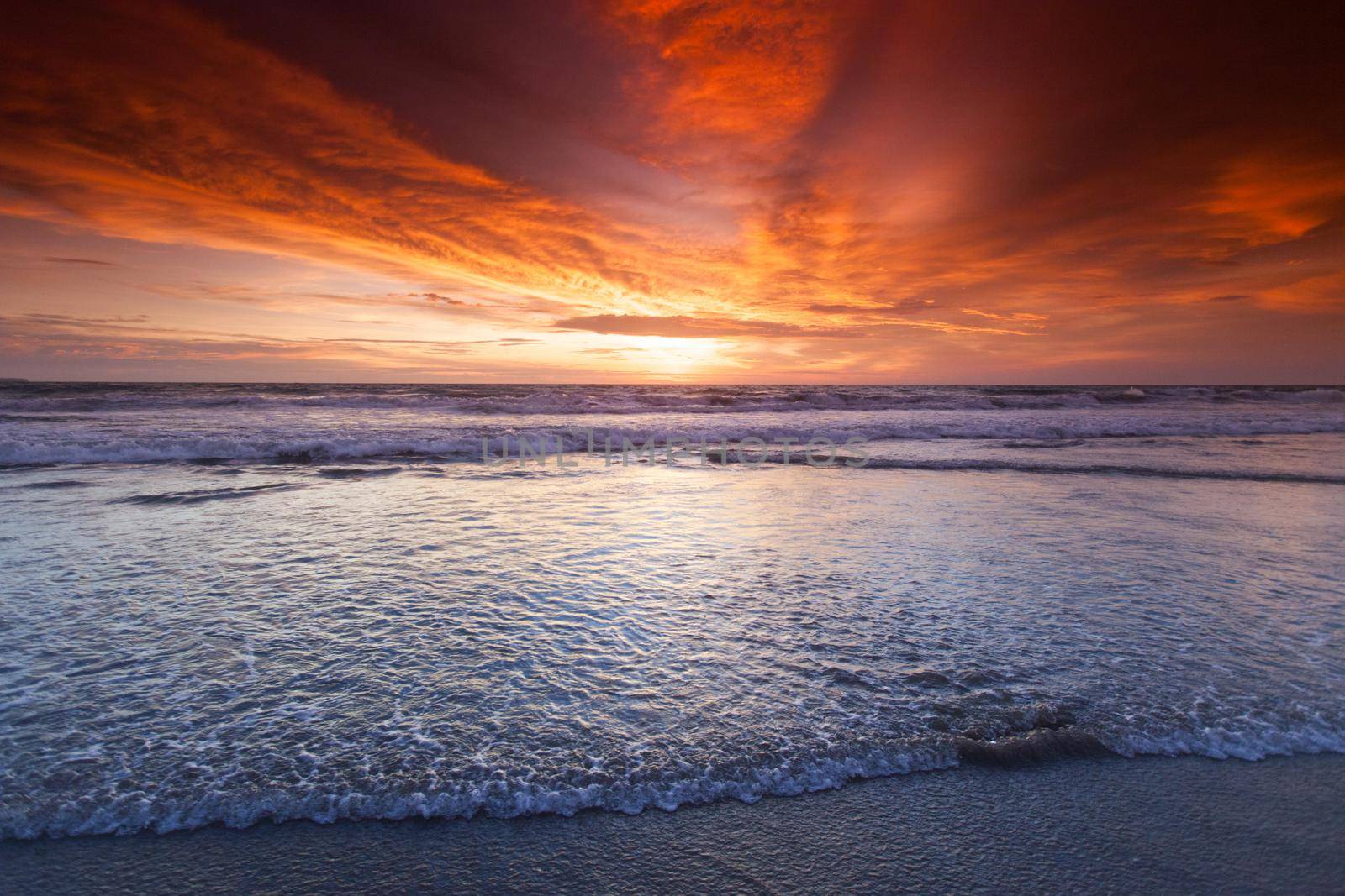 Radiant sunset from Bali Double Six beach surf waves and colorful clouds