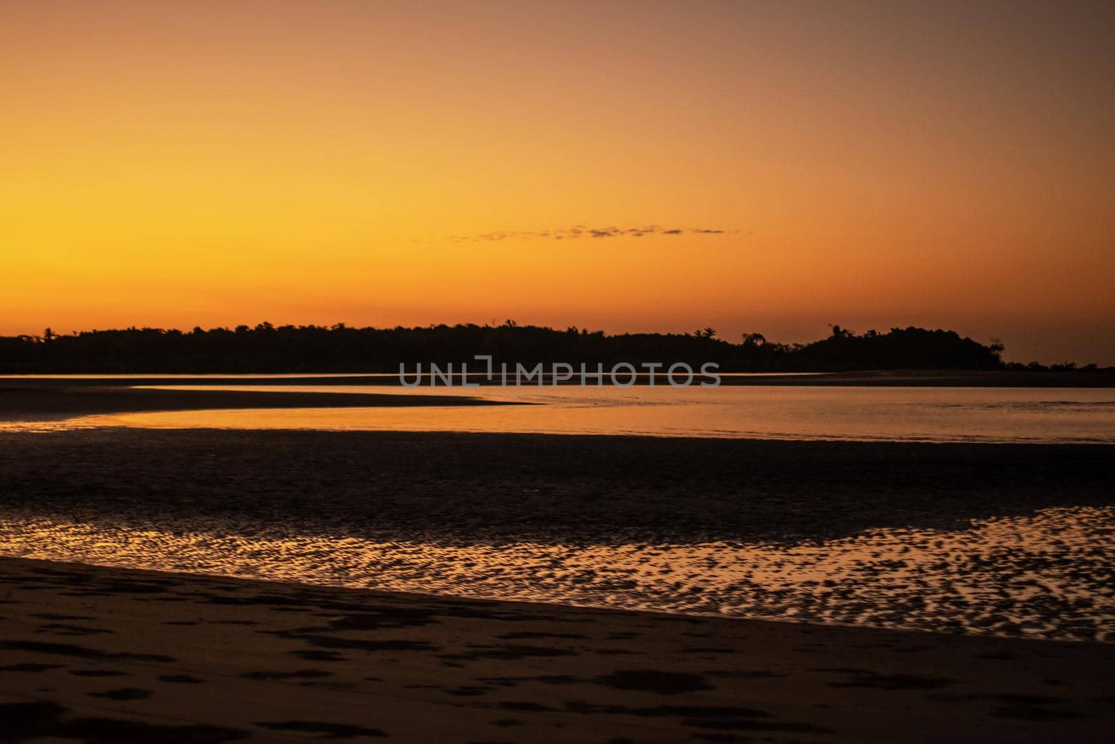 A sand beach during low tide and a bright orange sunset, peace and quiet, near Ngwesaung, Irrawaddy, western Myanmar