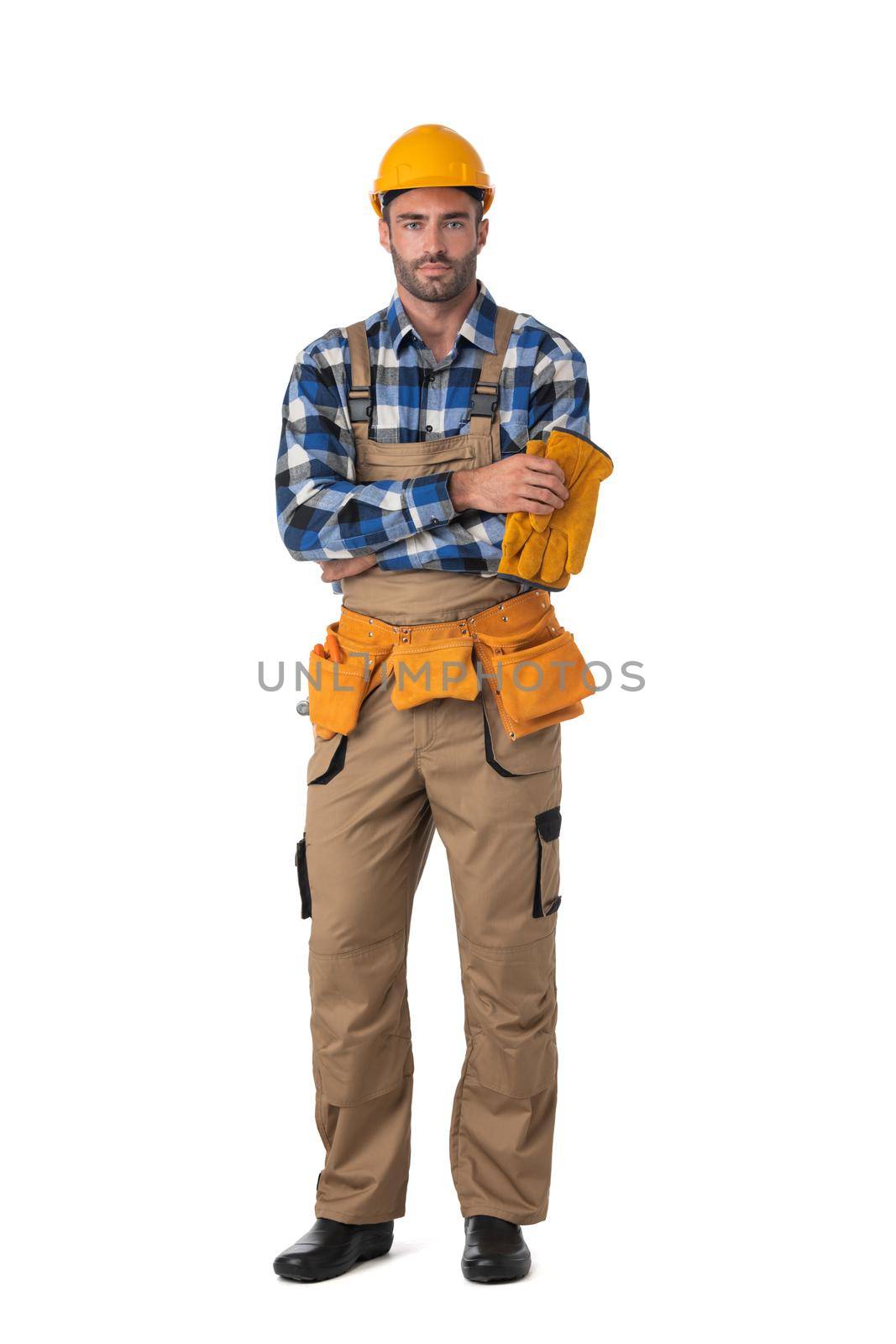 Contractor worker in coveralls and hardhat standing with arms crossed isolated on white background, full length portrait