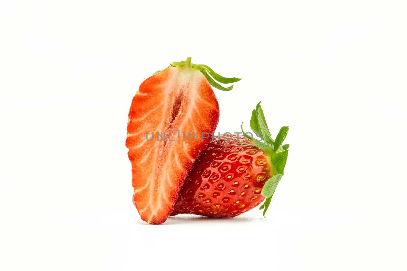 Whole strawberry fruit and half isolated on white background