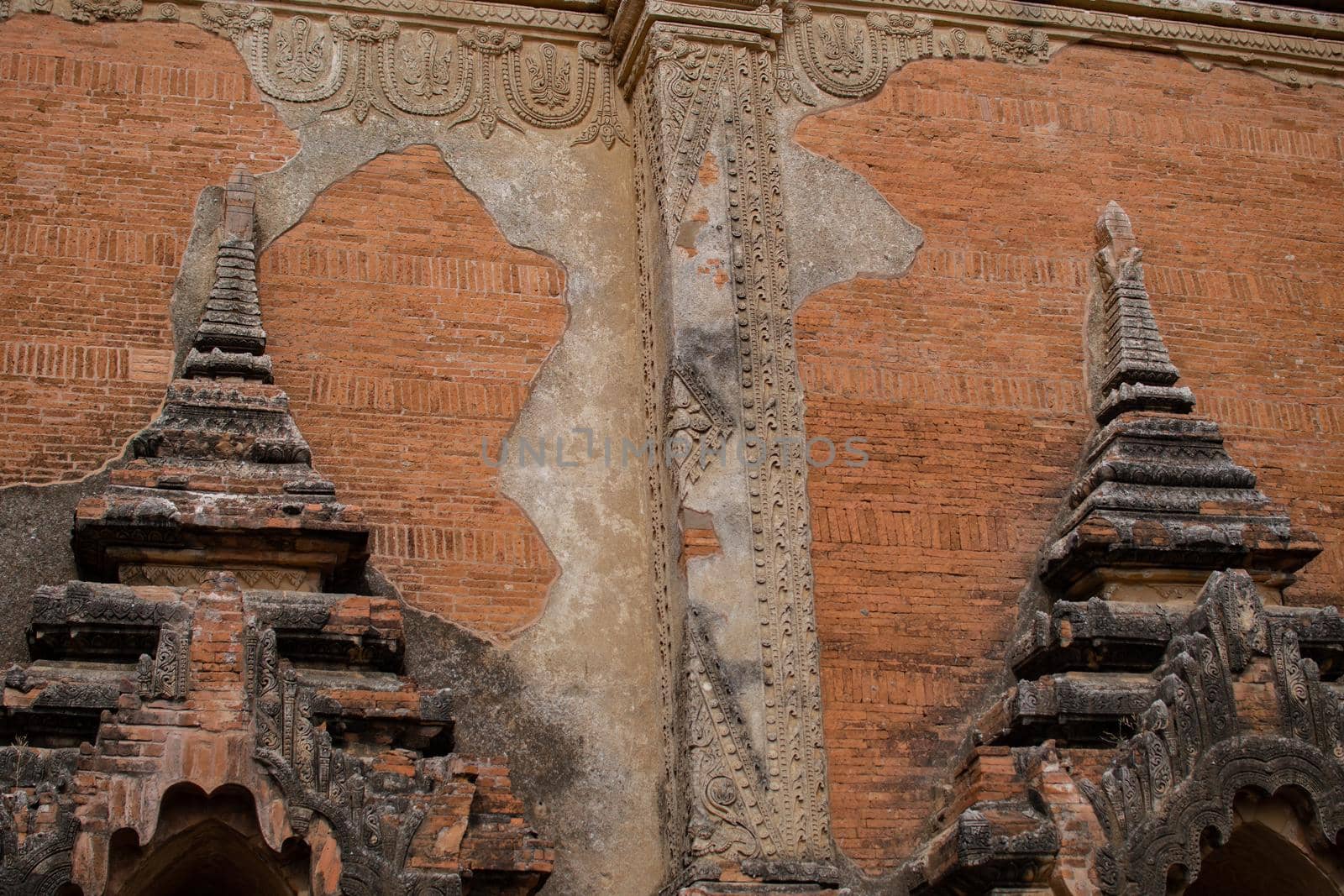 A beautifully decorated brick exterior wall of a historic temple in Bagan, Myanmar