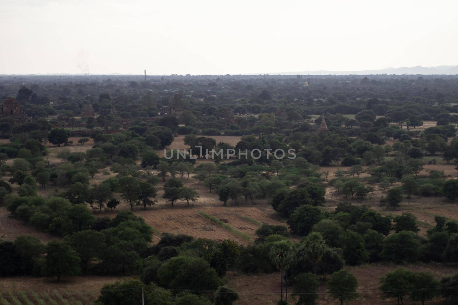 BAGAN, NYAUNG-U, MYANMAR - 3 JANUARY 2020: Looking out over the vast plains of Bagan with its historical temples and fields from the tall Nan Myint viewing tower