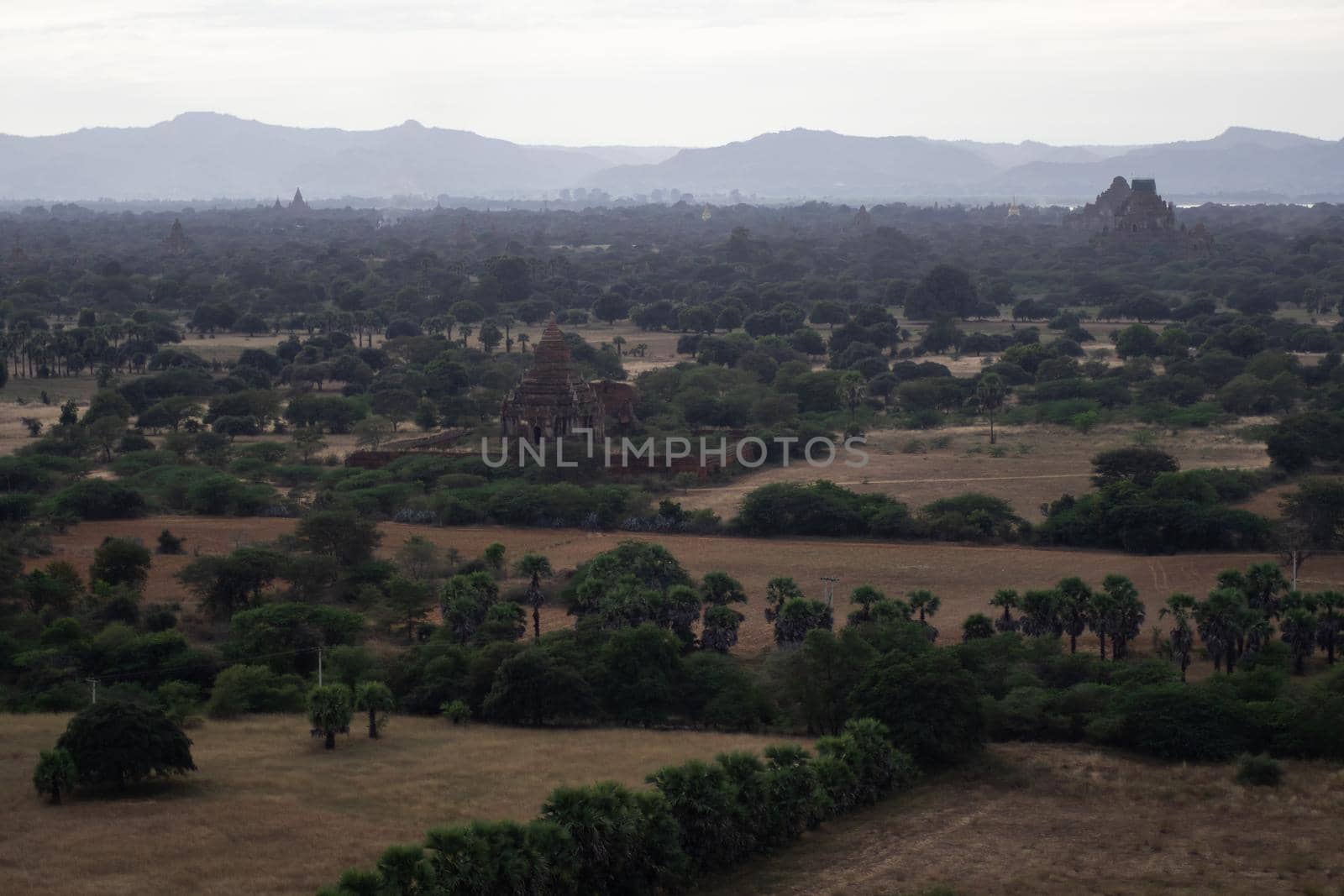 BAGAN, NYAUNG-U, MYANMAR - 3 JANUARY 2020: Looking out over the vast plains of Bagan with its historical temples and fields from the tall Nan Myint viewing tower