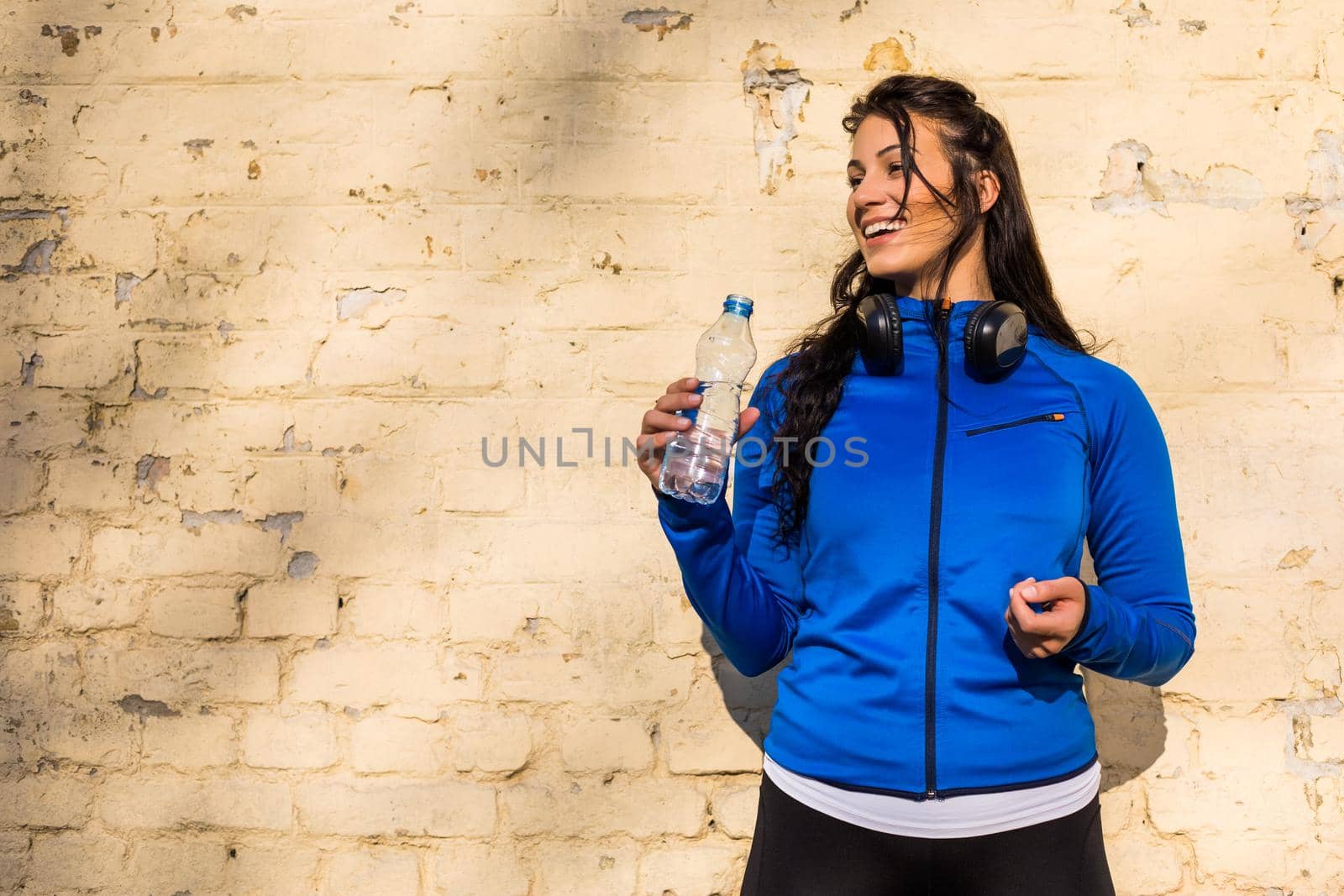 Sporty  woman drinking water by Bazdar