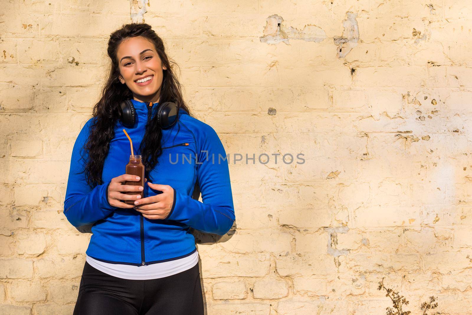 Sporty woman drinking smoothie by Bazdar