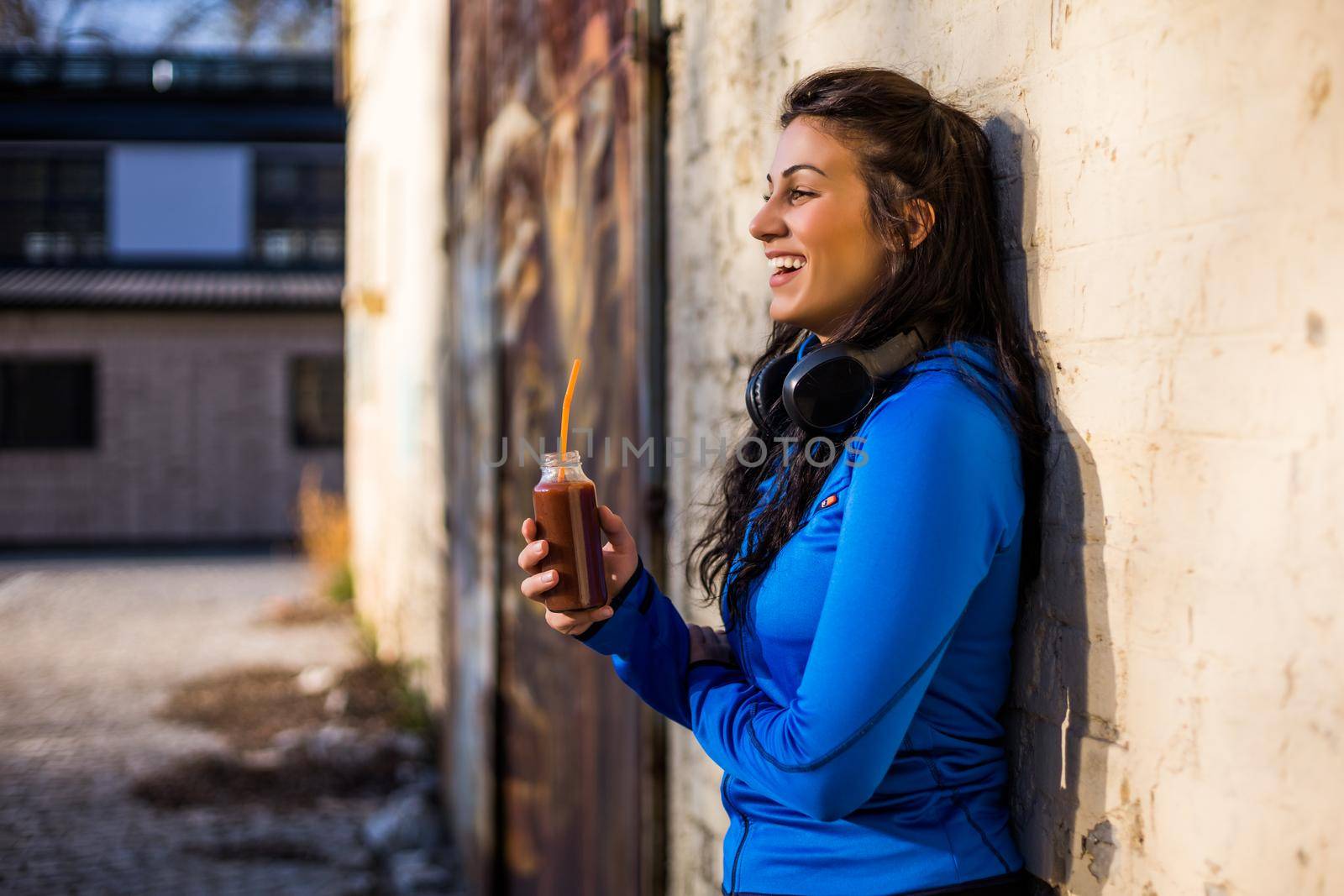 Sporty woman  drinking smoothie by Bazdar