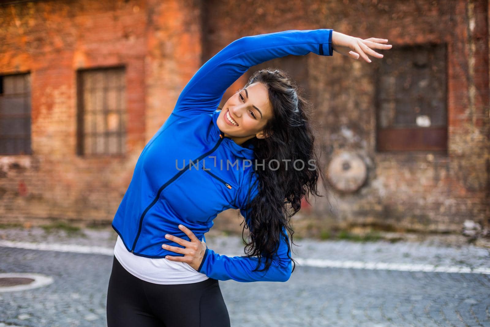 Beautiful woman enjoys  exercising outdoor.