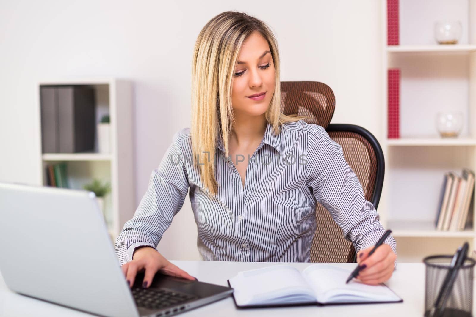 Beautiful businesswoman working at her office.