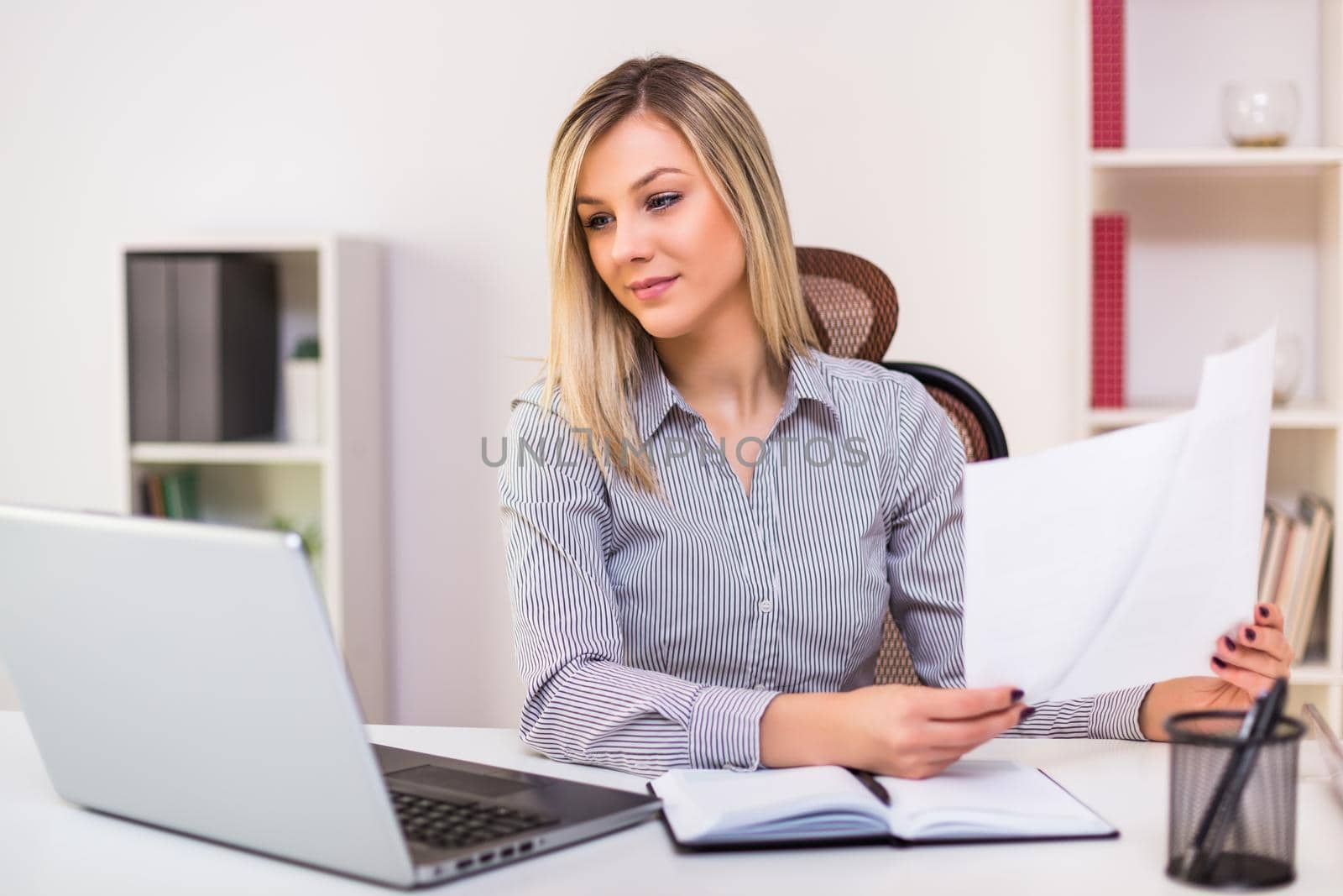 Businesswoman working at  office by Bazdar