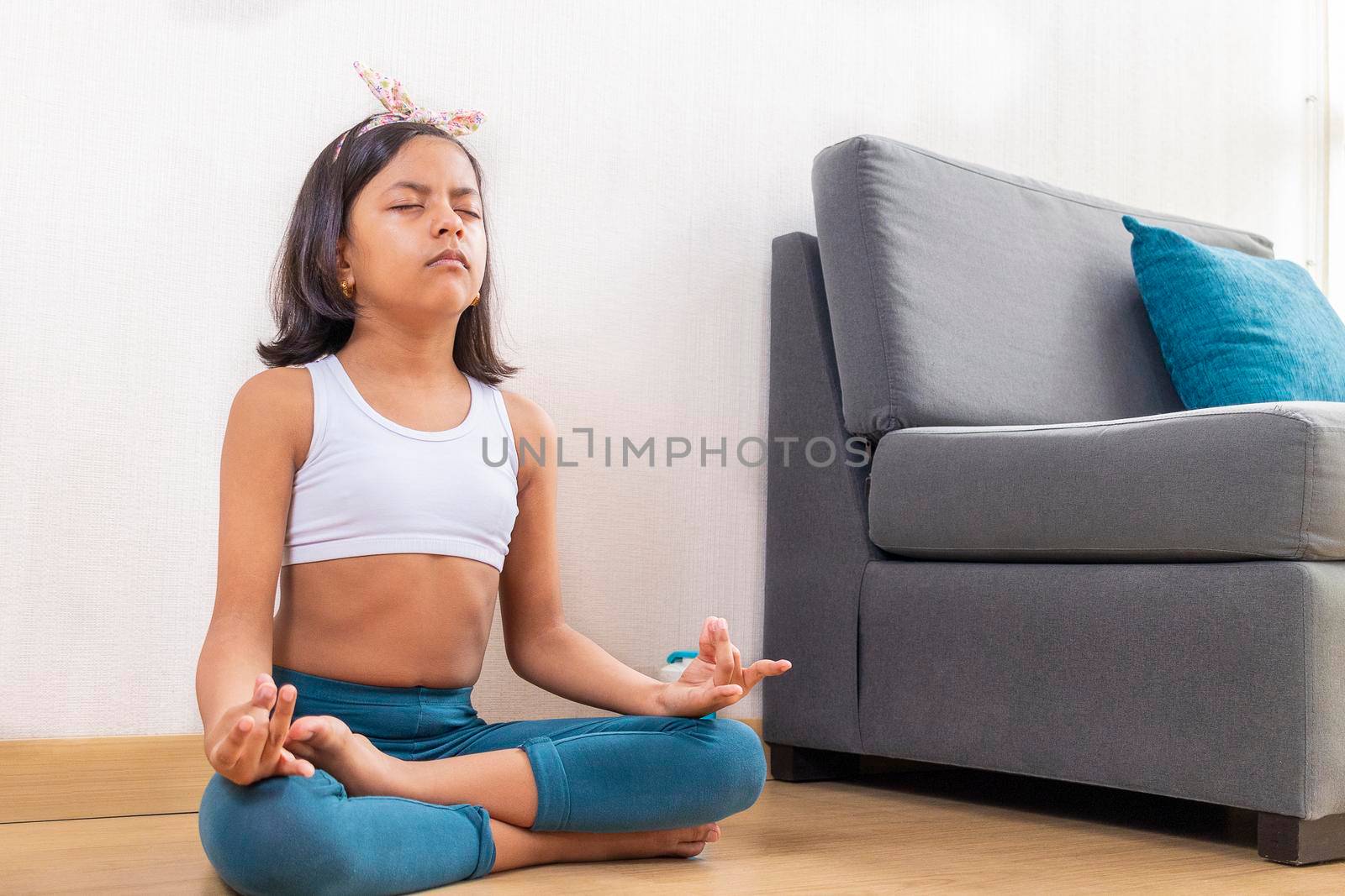 Teen girl doing yoga at home