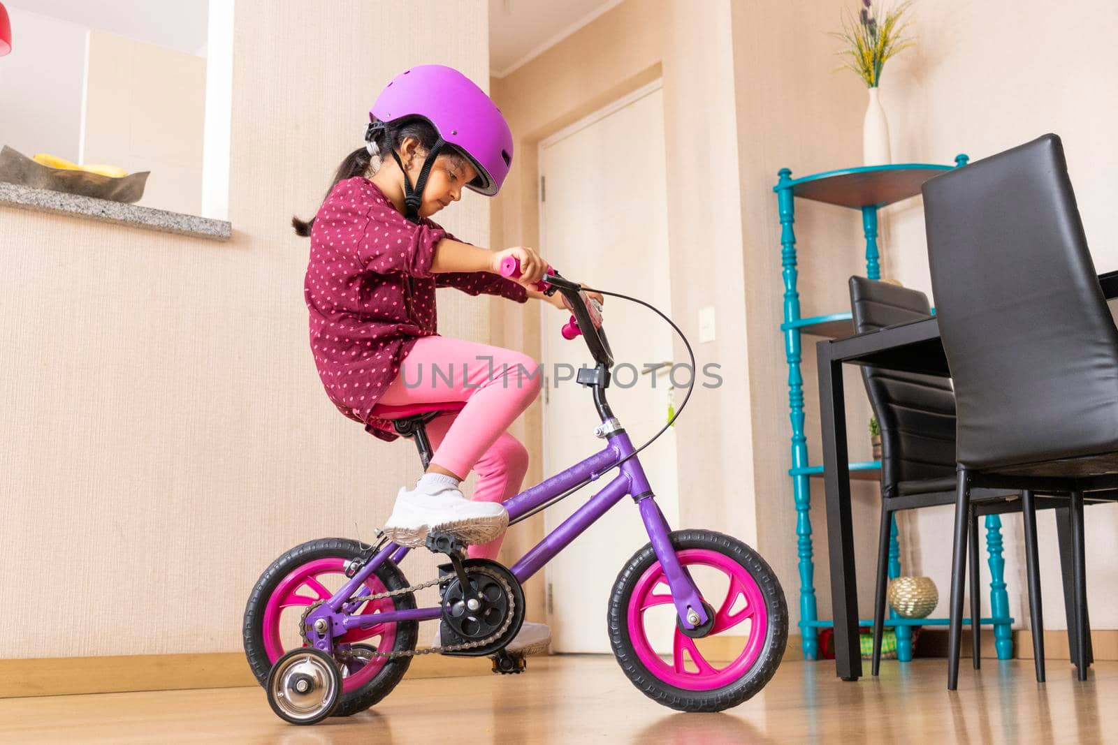 Little girl is riding a bicycle in her living room by eagg13