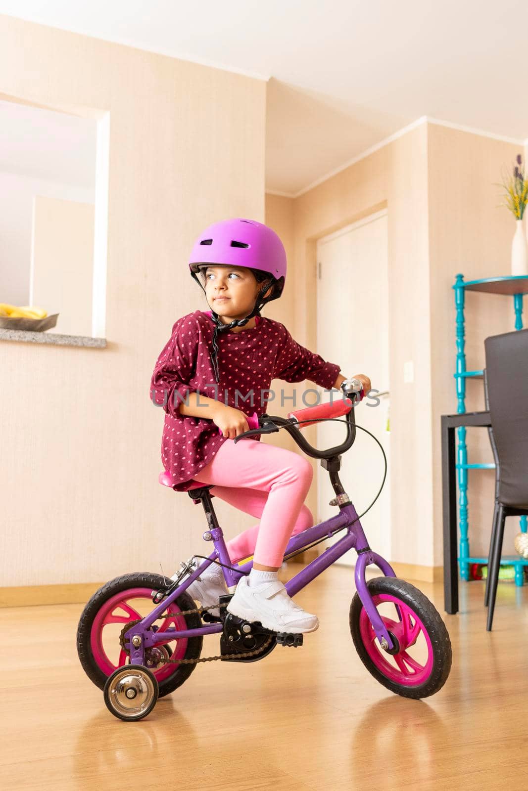 Little girl is riding a bicycle in her living room by eagg13