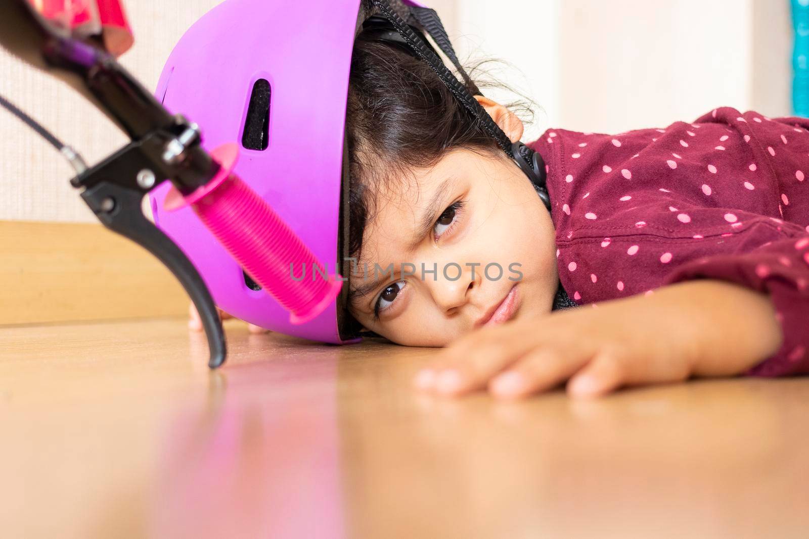 Sad little girl fell to the ground while playing with her bicycle in the house by eagg13