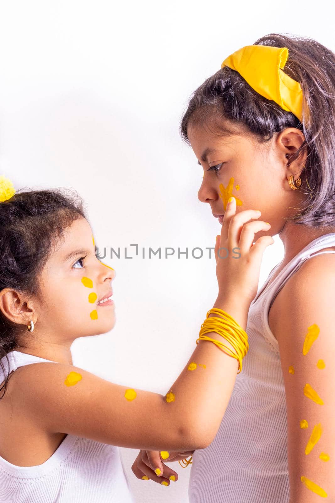 Two little girl, with her face painted to celebrate the yellow day