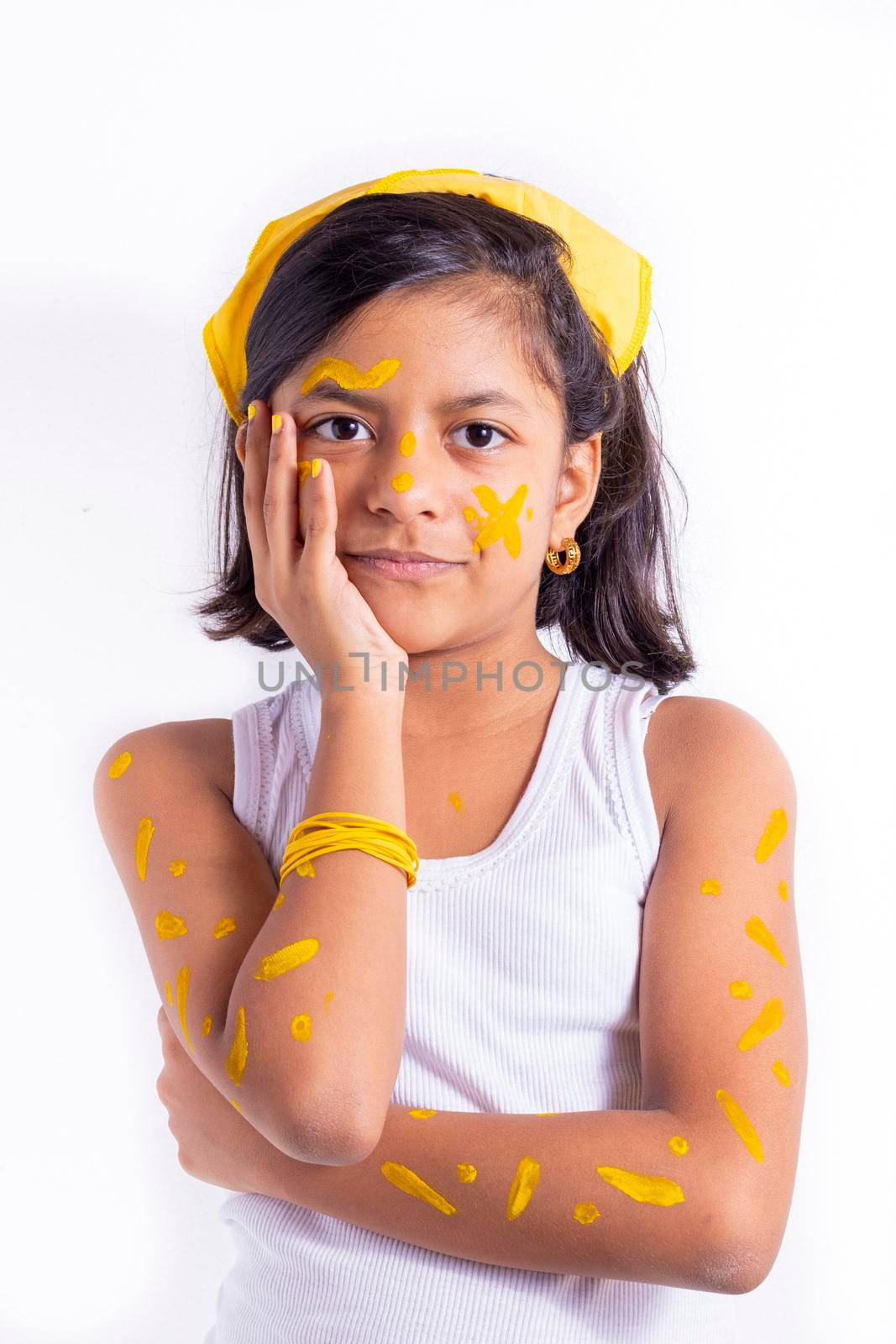 Happy little girl, with her face painted to celebrate the yellow day